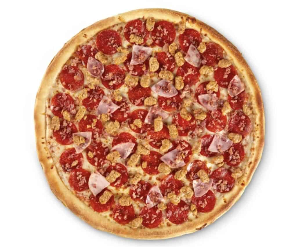 Freshly baked pizza with pepperoni, chicken, and cheese on a golden crust.