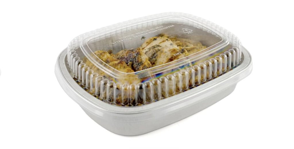 Prepared cooked chicken in a plastic container for takeout or delivery.